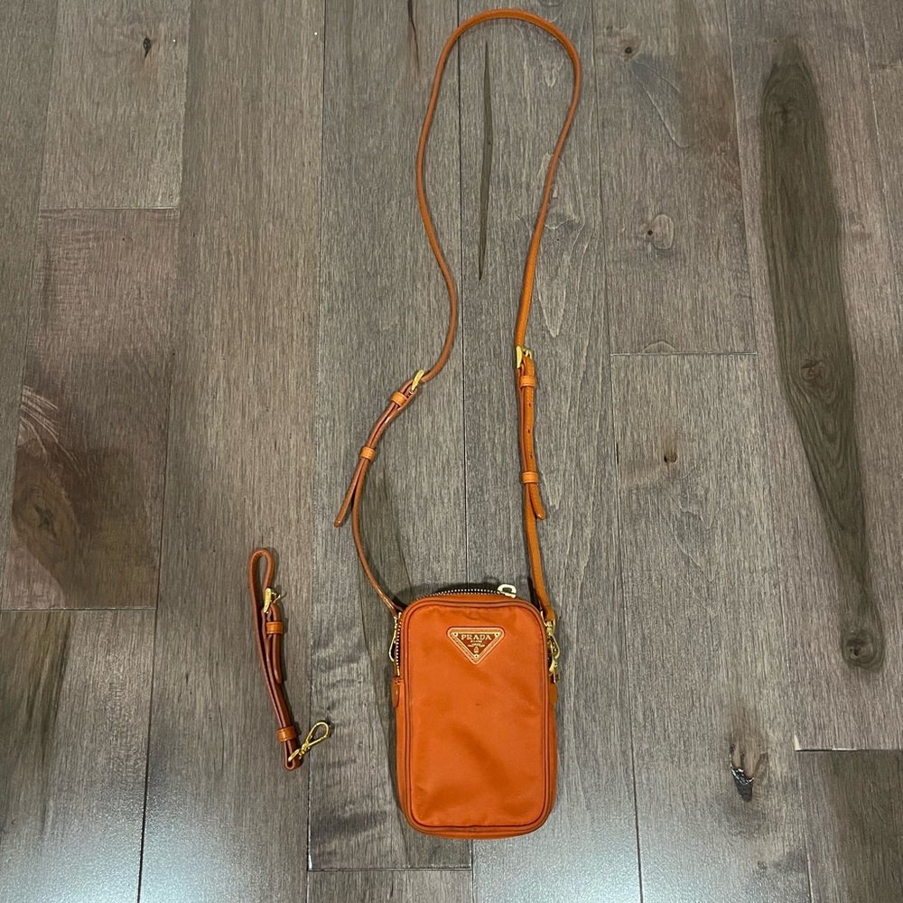 Orange Prada mini wristlet crossbody bag